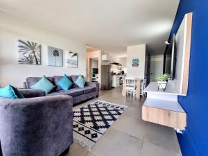 a living room with a couch and a table at Beautiful Chaka's Cove apartment in Ballito