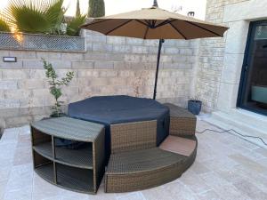 a table and chairs under an umbrella on a patio at Studio Nîmes in Nîmes