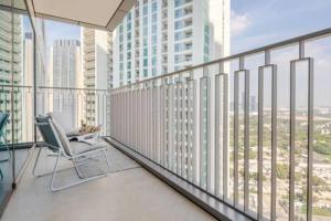 a balcony with a chair in a large building at Frank Porter - Downtown Views II T3 in Dubai