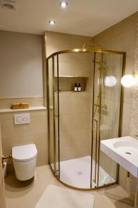 a bathroom with a shower and a toilet and a sink at Oakview in Colchester