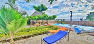 a patio with chairs and a swimming pool at Villa Francesca Boutique Hotel in Uroa