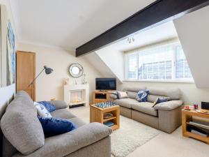 a living room with two couches and a tv at 1 Bed in Milford on Sea 79332 in Milford on Sea