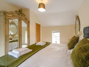 a bedroom with a large bed with a large mirror at 3 Bed in Crich 78717 in Crich