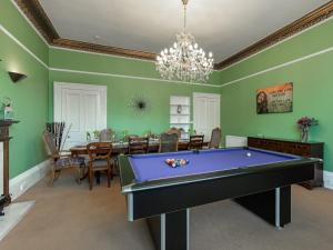 a dining room with a purple pool table in it at 5 Bed in Melrose 79418 in Melrose