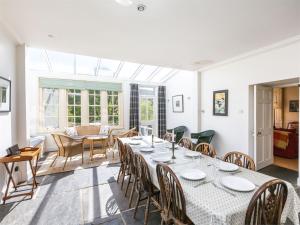 a dining room with a long table and chairs at 5 Bed in Kilfinan CA007 in Kilfinan