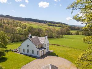an aerial view of a white house in a field at 5 Bed in Kilfinan CA007 in Kilfinan