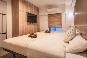 Postel nebo postele na pokoji v ubytování Apartment Hotel 11 Shinsaibashi