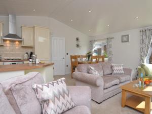 a living room with a couch and a table at 2 Bed in Okehampton 80373 in Okehampton