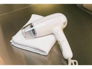 a hair dryer sitting on top of a towel at ROI SPACE KAGOSHIMA - Vacation STAY 87752 in Kagoshima