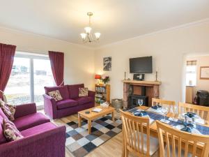 a living room with a couch and a table at 2 Bed in Edzell CA300 in Edzell
