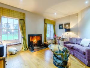 a living room with a couch and a fireplace at 1 Bed in Fettercairn 77762 in Fettercairn