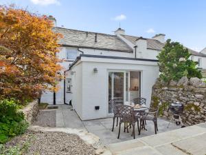 a house with a patio with a table and chairs at 1 Bed in Cartmel 78659 in Cartmel