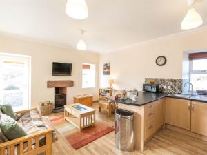a kitchen and living room with a couch and a table at 1 Bed in Edzell CA335 in Edzell
