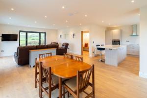 a kitchen and a living room with a table and chairs at Dingle Way Rest ,Luxury holiday home in Dingle