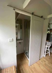 a sliding door in a room with a kitchen at Mulberry Studio in Hawkhurst