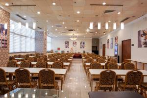 a large room with tables and chairs in it at Magnificent International Hotel in Shanghai