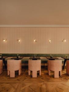 a row of tables and chairs in a restaurant at Hotel Zum Hirschen Salzburg in Salzburg