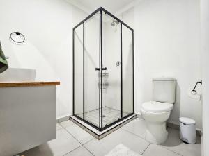 a shower stall in a bathroom with a toilet at Micro Urban Oasis in Pretoria