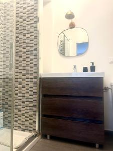 a bathroom with a sink and a mirror at Taormina Casa Sarina in Taormina