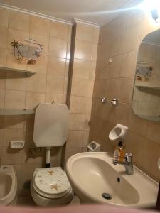 a small bathroom with a sink and a toilet at Calma apartment in Athens