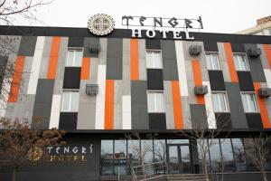 a hotel with a sign on the front of it at Tengri Hotel in Aktau