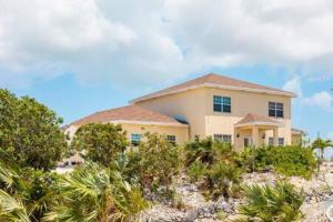 a house on top of a hill with trees at Charming Guest House near Chalk Sound and the Beach in Providenciales