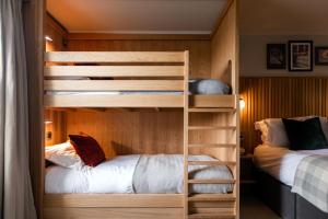 a bunk bed in a room with two beds at The Park Hotel in Teddington