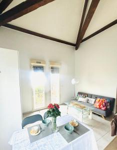 a living room with a table and a couch at Villa Reine in Nice