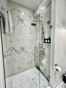 a bathroom with a shower with marble tiles at Camillas Holiday home Copenhagen City Centre in Copenhagen