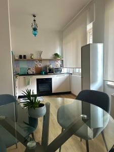 a kitchen with a glass table and a refrigerator at Taormina Casa Sarina in Taormina