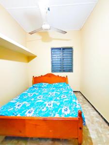 a bedroom with a bed and a ceiling fan at SSM GUEST INN in Trincomalee