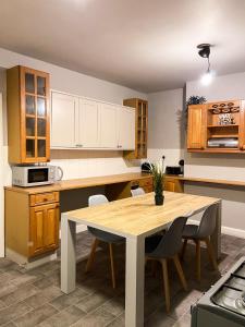 a kitchen with a wooden table and chairs at 3 Bedroom House in York