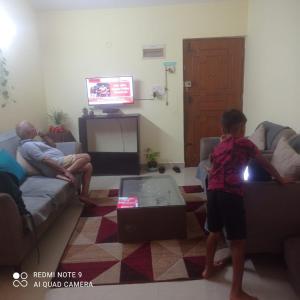 a young child playing a video game in a living room at 2 bhk dream resort porvorim in Old Goa