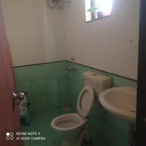 a bathroom with a toilet and a sink at 2 bhk dream resort porvorim in Old Goa