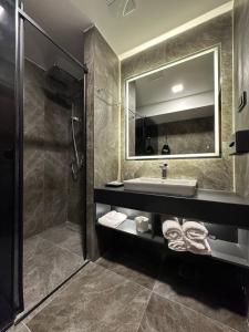 a bathroom with a sink and a mirror at Hotel Macedonia Square in Skopje