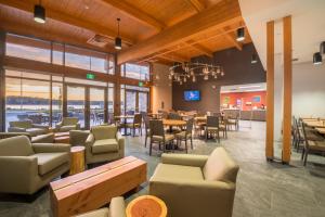 a restaurant with couches and tables and chairs at Comfort Inn & Suites in Campbell River