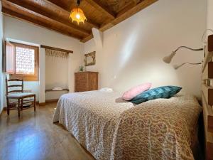Un dormitorio con una cama con dos almohadas encima. en Etxetxikia, en Ochagavía