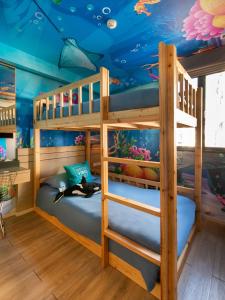 a bunk bed in a room with a fish ceiling at Cross Vibe Bangkok Sukhumvit in Bangkok