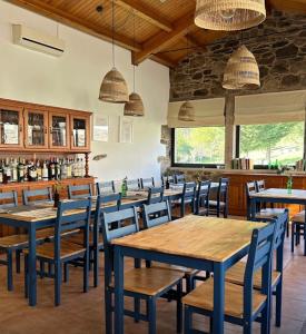 a dining room with wooden tables and chairs at Casa Bolboreta in Palas de Rei 