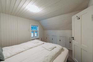 a white bedroom with a bed in a room at Day Dream Central Akureyri Three Bedroom Apt in Akureyri