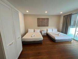 a room with two beds and a window at TreeHaus 38 Moulmein by SSL - Pulau Tikus Georgetown in George Town