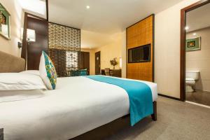 Postel nebo postele na pokoji v ubytování SSAW Boutique Hotel Hefei Intime Centre