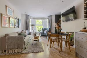 a living room with a couch and a table at Cohost Partners | Close to City Centre | One BR! in Cardiff