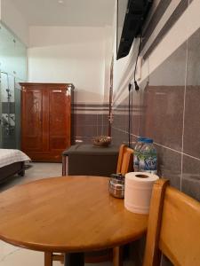 a wooden table in a room with a table and a chair at VIEW HOTEL- TRÀM CHIM in Tràm Chim