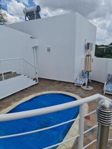 a balcony with a blue pool on a ship at Villa Saffier in Windhoek