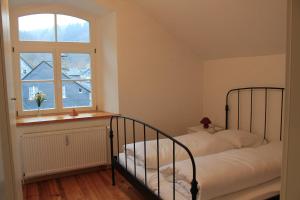 a bedroom with a bed and a window at Zum alten Landrat in Monschau +20 photos
