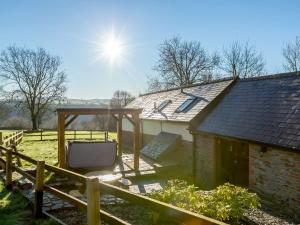 une maison avec une télévision et une clôture en bois dans l'établissement 2 Bed in South Molton 86642, à Knowstone