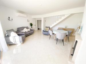 a living room with a couch and a table at Casa Rostam - Duplex avec Terrasses - Ferragudo in Ferragudo