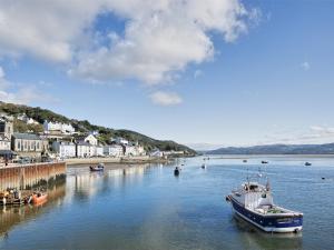 a boat is docked in a body of water at 2 Bed in Aberdovey DY017 in Aberdyfi