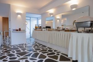 a restaurant with a long counter in a room at Maryo Village in Naousa